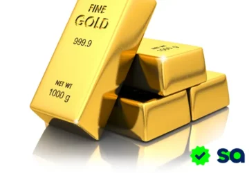 Lingotes de oro brillantes apilados, símbolo clásico de invertir en oro de forma segura y estable.